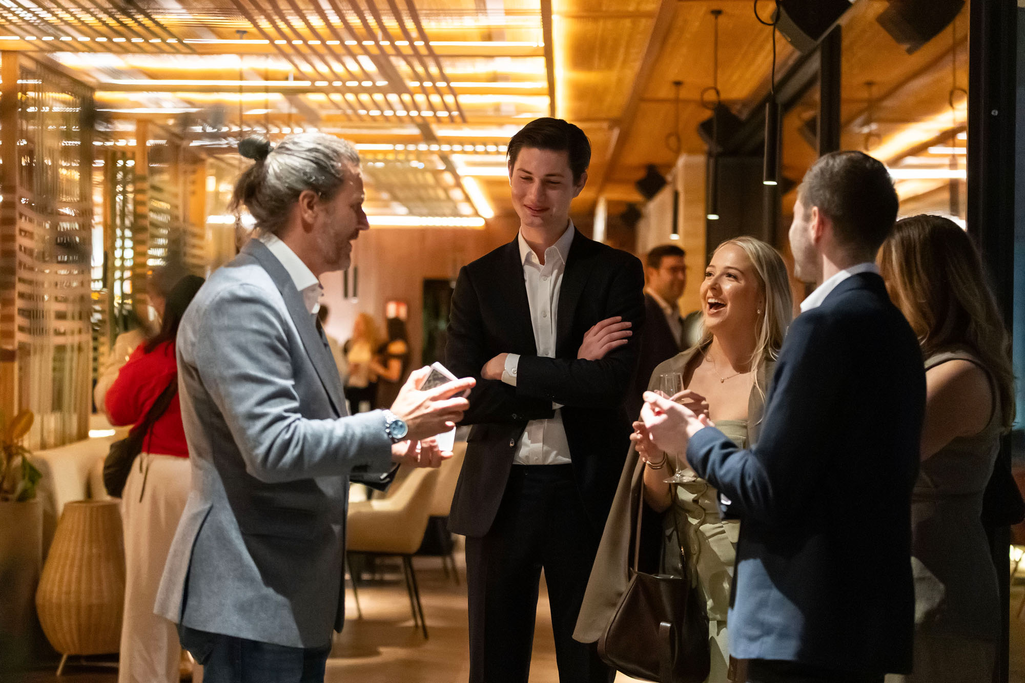 Corporate magician performing close-up magic for guests at a premium business event